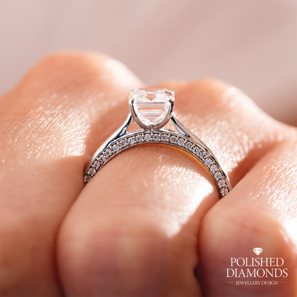Diamond engagement ring with hidden stones set in band