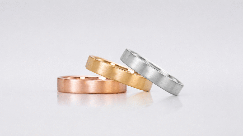 Brushed rose gold ring, yellow gold ring, and white gold ring