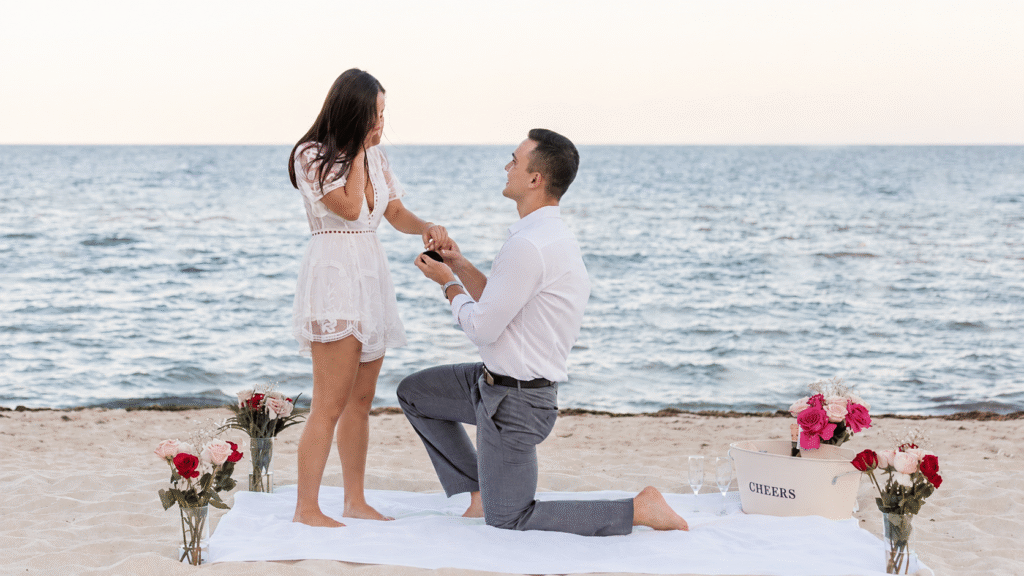 Romantic beach proposal with roses and champagne