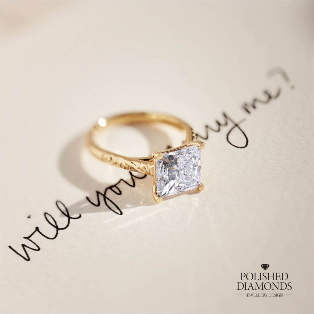 Engagement ring on top of a "will you marry me" letter
