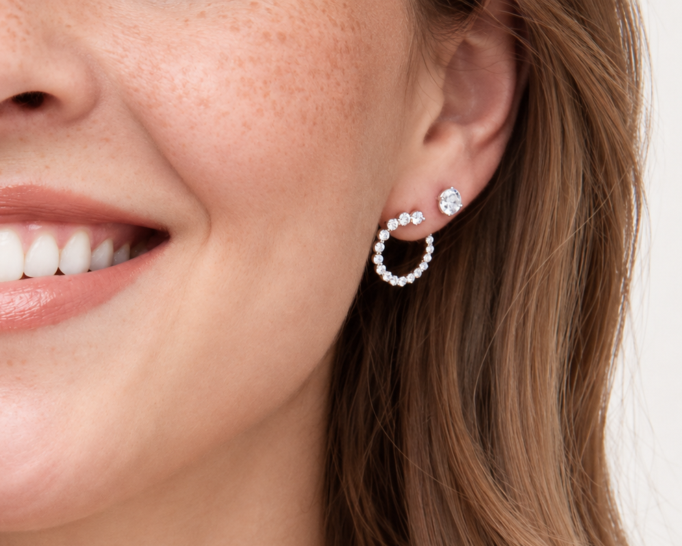 Diamond stud and hoops on ear